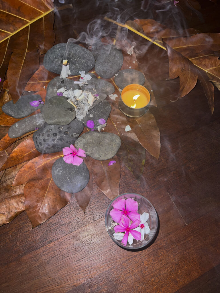 Flowers and stones are laid out for ritual when becoming a certified yoga instructor